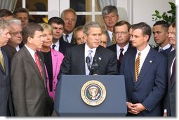 Standing with members of Congress, President George W. Bush discusses America's position on Iraq in the Rose Garden Thursday, Sept. 26. "We are moving toward a strong resolution. And all of us, and many others in Congress, are united in our determination to confront an urgent threat to America," explained the President. "And by passing this resolution we'll send a clear message to the world and to the Iraqi regime: the demands of the U.N. Security Council must be followed." White House photo by Paul Morse.