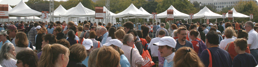 A crowd of people at the National Book Festival, with tents in the background.