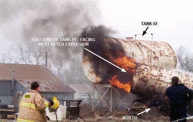 Photo 4: Photograph of Tank #1 immediately after explosion occurred, showing the final resting position of the east end of the tank.  