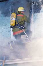 Firefighter in window of structure fire