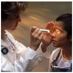 Physician checking vision of little girl