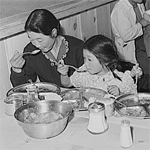 Japanese family eating their first meal. All meals are served in mess halls.