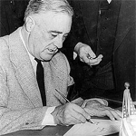 President Roosevelt signing the declaration of war against Japan.