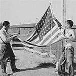 Rupert, Idaho. Japanese-Americans taking down their flag in the evening.