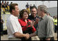 President George W. Bush shakes hands with California Governor Arnold Schwarzenegger as he talks with the media after touring the Rancho Bernardo neighborhood Thursday, Oct. 25, 2007, with Senator Dianne Feinstein, D-Calif., and FEMA Director David Paulison. Said the President: "To the extent that people need help from the federal government, we will help. My job is to make sure that FEMA and the Defense Department and the Interior Department and Ag Department respond in a way that helps people get the job done." White House photo by Eric Draper