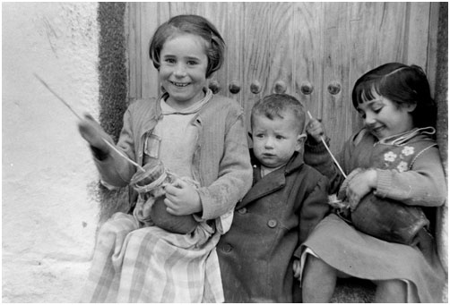 Castilla-LaMancha, Spain: children playing ximbombas, Dec. 1952