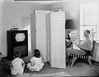 Father Reading Newspaper, Two Children Viewing Television