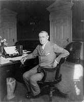 Woodrow Wilson, full-length portrait, seated at desk