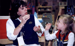 Photo of teacher and student signing in classroom