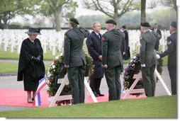 Queen Beatrix of The Netherlands and President George W. Bush pause in respect before wreaths at the Netherlands American Cemetery Sunday, May 8, 2005, in Margraten, honoring those who served during World War II.  White House photo by Eric Draper