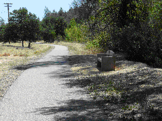 Flat section of a paved walking and jogging trail along the side of a road that fire fighters used for fitness training.