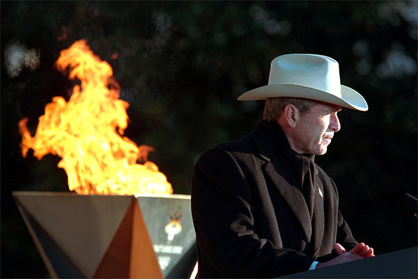 President George W. Bush speaks during the 2002 Olympic Torch Relay Ceremony on the South Lawn Dec. 22. "Each torch bearer's story is a lesson in citizenship and courage and compassion," said the President announcing the two torch runners, Liz Howell and Eric Jones. Both runners were profoundly affected by the Sept. 11 attacks. White House photo by Paul Morse.