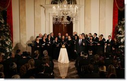 Tenor Alberto Mizrahi, the cantor at Chicago's historic Anshe Emet Synagogue, is joined by the Zamir Chorale as they entertain during the lighting of the Menorah Monday, Dec. 10, 2007, in the Grand Foyer of the White House. White House photo by Joyce N. Boghosian