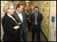 Secretary Spellings and California Governor Arnold Schwarzenegger view students artwork, including artwork of the Governor, with Principal Francisco J. Velasco at Otay Elementary School.