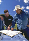 NRCS conservationist (left) discusses conservation plan with producer (right).