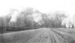 1937 photo shows dust clouds billowing over Highway 59 south of Lamar, Colorado.  (NRCS image — click to enlarge)