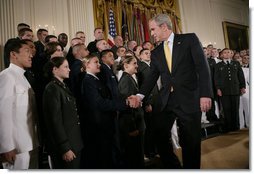 President George W. Bush congratulates newly commissioned members of the Joint Reserve Officer Training Corps Thursday, May 17, 2007, in the East Room of the White House, after U.S. Secretary of Defense Robert Gates administered the commissioning oath to the ROTC members. White House photo by Eric Draper