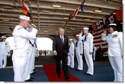 Sailors salute Vice President Dick Cheney as he departs the USS Ronald Reagan after the aircraft carrier's commissioning ceremony at the Norfolk Naval Station in Norfolk, Va., July 12, 2003.   White House photo by David Bohrer