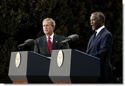 Presidents Bush and Mbeki speak to the media at the Guest House in Pretoria, South Africa, Wednesday, July 9, 2003. “I must say, President (Bush), that at the end of these discussions, we, all of us, feel enormously strengthened by your very, very firm and clear commitment to assist us to meet the challenges that we've got to meet domestically and on the African continent,” said President Mbeki.  White House photo by Paul Morse