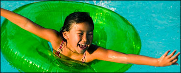 Photo: A girl floating in a swimming pool