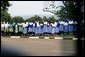 School children watch as the Presidential motorcade passes through Entebee, Uganda, July 11, 2003. White House photo by Paul Morse.
