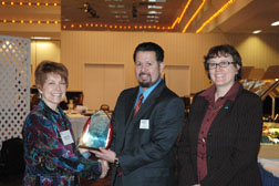 J.R. Flores presented Manager Workforce Diversity Award. North Dakota State Conservationist J.R. Flores (center) receives the Manager Workforce Diversity Award from NRCS Associate Chief Dana York and NRCS National Civil Rights Chair Joyce Swartzendruber. J.R. was commended for his direct involvement in promoting equal opportunity and work with students. NRCS image.