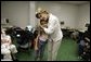 First Lady Laura Bush hugs a young girl displaced by Hurricane Katrina during her visit Friday, Sept. 2, 2005, to the Cajundome at the University of Louisiana in Lafayette. "Some things are working very, very well in Louisiana," Mrs. Bush said. "And certainly this center is one of those." White House photo by Krisanne Johnson