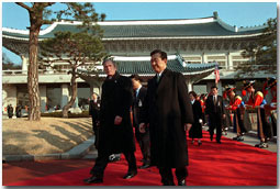 President George W. Bush and President Kim Dae-Jung proceed through an arrival ceremony at The Blue House in Seoul, Republic of Korea, Feb. 20. 