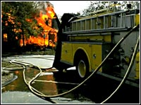 Photo of a fire truck in front of a fire.