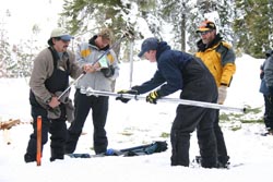 Snow survey students measure snow.