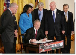 President George W. Bush signs H.R. 7081, The United States-India Nuclear Cooperation Approval and Nonproliferation Enhancement Act, Wednesday, Oct. 8, 2008, in the East Room at the White House. President Bush is joined on stage by, from left, Rep. Joseph Crowley, D-N.Y., Rep. Eliot Engel, D-N.Y., Secretary of State Condoleezza Rice, Sen. Chris Dodd, D-Conn., Senator John Warner of Virginia, Energy Secretary Samuel Bodman, and India's Ambassador to the United States Ronen Sen. White House photo by Eric Draper