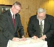 missouri state conservationist roger a. hansen, left, and don harkins, president and cceo of the rehabilitation institute of kansas city, sign memorandum of understanding. 