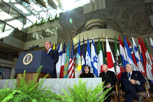 "Today, I call for a new compact for global development, defined by new accountability for both rich and poor nations alike," states President George W. Bush in his address at the Inter-American Development Bank in Washington, D.C. March 14. Accompanying the President from left to right are: the lead singer of U2, Bono; Cardinal McCarrick and Worldbank President Jim Wolfensohn. White House photo by Tina Hager.