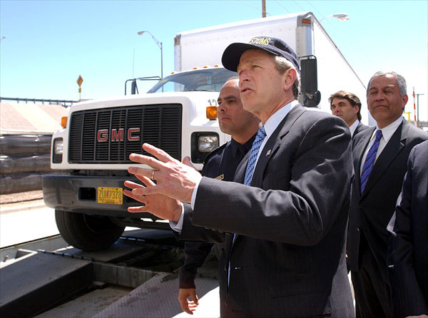 President George W. Bush reviews the Vehicle and Cargo Inspection System during a tour of the cargo dock at the Bridge at the Americas in El Paso, Texas, Thursday, March 21. Also pictured, from left, are Port Operations Director David Longoria, Texas Governor Rick Perry and Congressman Henry Bonilla (R-23rd). "I want this border to be modern; I want it to have the very best technology," said the President upon his arrival at the El Paso airport. "I don't want it to be a neglected part of our country. I want it to be a place where we spend a lot of time and focus on it, so that it works the best it can possibly work." White House photo by Eric Draper.