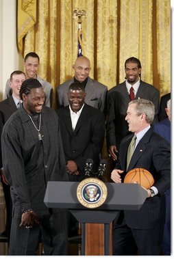 During a ceremony honoring the Detroit Pistons for winning the 2004 NBA Championship, President George W. Bush shares a laugh with basketball player Ben Wallace in the East Room, Jan. 31, 2005.  White House photo by Paul Morse