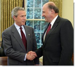 President George W. Bush offers congratulations to John Negroponte, Thursday, April 21, 2005, in the Oval Office after Mr. Negroponte was sworn in as the Director of National Intelligence.  White House photo by Eric Draper