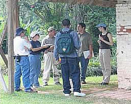 Group of people standing by an old building.