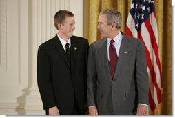 President George W. Bush congratulates Scott Elder, 15, of Chino Hills High School in Chino Hills, Calif., on receiving the President’s Environmental Youth Award in the East Room of the White House April 21, 2005.  White House photo by Paul Morse
