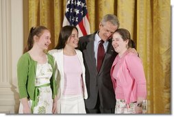 President George W. Bush congratulates ninth graders from Hawken School of Geauga County, Ohio, on receiving the President’s Environmental Youth Award in the East Room of the White House April 21, 2005. Members include, from left to right, Karoline Evin McMullen, 14, Angela Primbas, 14, and Amanda Weatherhead, 15.  White House photo by Paul Morse