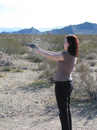 Girl target shooting with a pistol