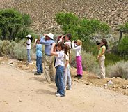 A group of bird watchers in a riparian area