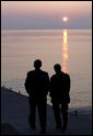 President George W. Bush and Russia's President Vladimir Putin take a sunset walk on a pier along the Black Sea during a visit by President and Mrs. Bush Saturday, April 5, 2008, to President Putin's summer retreat, Bocharov Ruchey, in Sochi, Russia. White House photo by Eric Draper