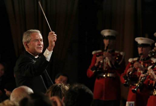 President George W. Bush leads the Marine Band Saturday, April 26, 2008, during the 94th Annual White House Correspondents' Association Dinner at the Washington Hilton Hotel. White House photo by Joyce N. Boghosian
