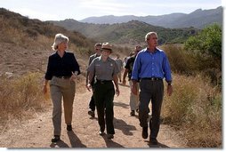 President George W. Bush walks with Secretary of the Interior Gale Norton, left, and Director of the National Park Service Fran Mainella at the Santa Monica Mountains National Recreation Area in Thousand Oaks, Calif. File photo.  White House photo by Paul Morse