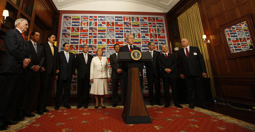 President George W. Bush is surrounded by leaders from the Western Hemisphere as he delivers a statement on free trade Wednesday, Sept. 24, 2008, at the Council of the Americas in New York City. Said the President, "Each of the 11 countries here has a free trade agreement with the United States, or one pending before Congress. Free and fair trade is in our mutual interests." White House photo by Eric Draper
