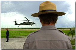 Marine One lands with President George W. Bush at Daniel Beard Center in Everglades National Park as Maureen Finnerty, Superintendent of Everglades National Park watches (Monday June 4). WHITE HOUSE PHOTO BY ERIC DRAPER