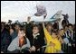 Air Force One stands at the ready for President George W. Bush as a crowd cheers while the aircraft's chief passenger speaks during the Arkansas Welcome at the Northwest Arkansas Regional Airport, Monday, Nov. 4. White House photo by Eric Draper.