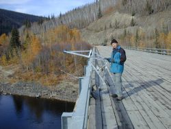 Hydrologist measuring streamflow on the Fortymile Wild & Scenic River from the Taylor Highway Bridge