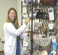 Sandy Patton displays some of the products produced by local vendors and artisans