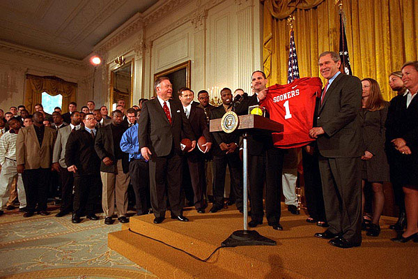 The Univerity of Oklahoma football team presents President George W. Bush with a jersey in the East Room of the White House
